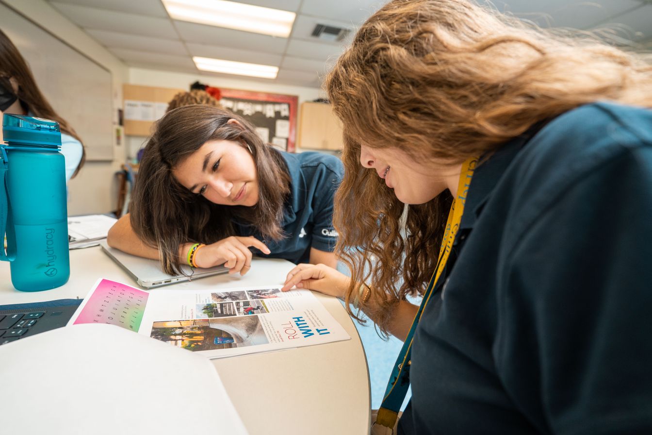 Two middle school students reviewing their work in Digital Mass Media class