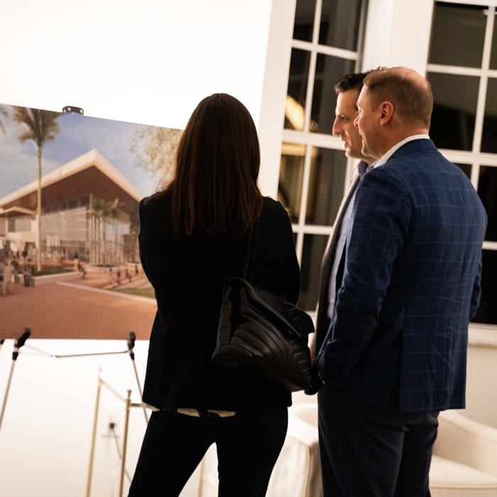 Two adults looking at a print
